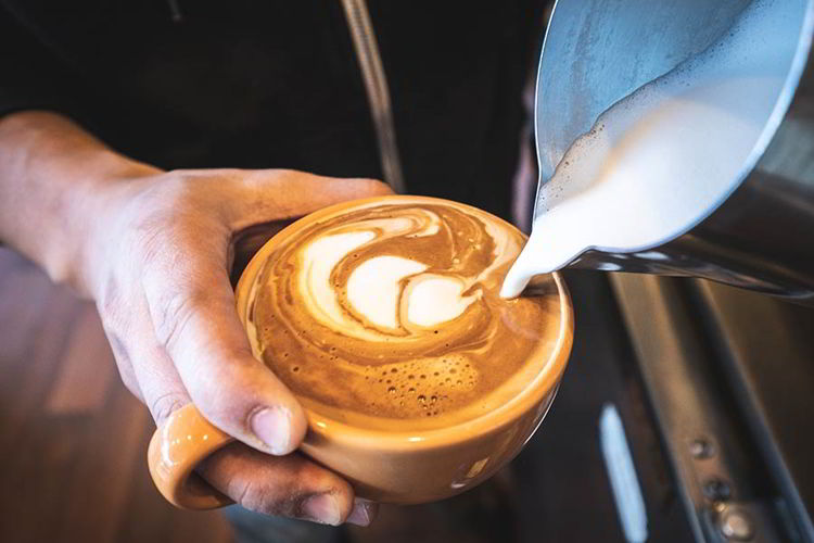 An image of someone pouring coffee.