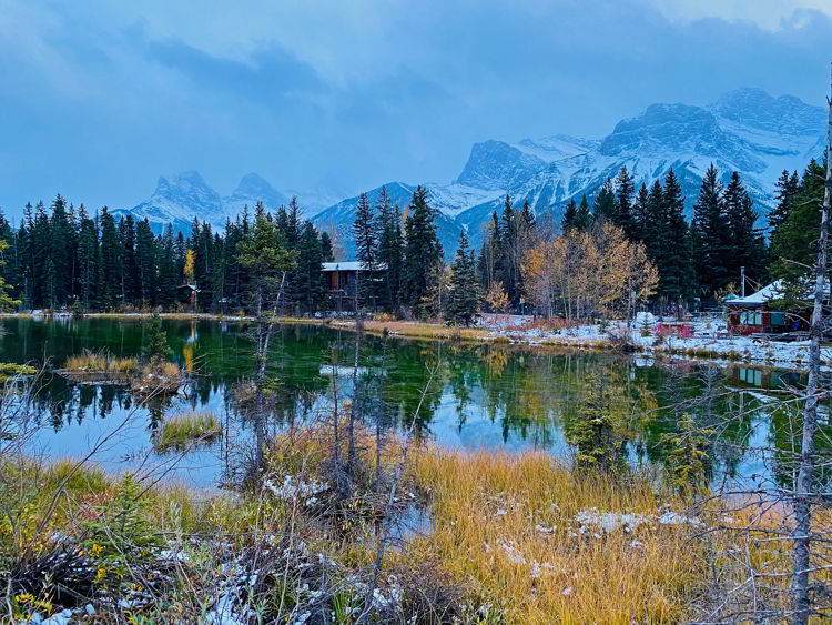 An image of a pond seen from a walking trail in Canmore - Canmore winter hikes and snowshoe trails. 