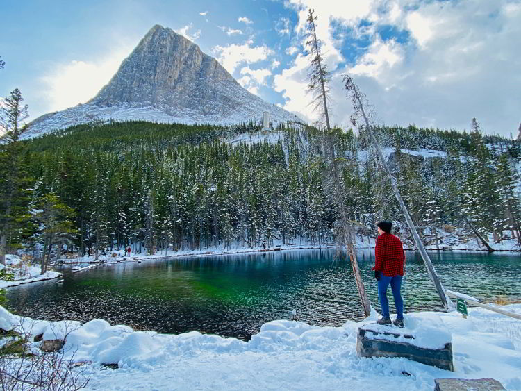An image of a woman at Grassi Lakes - Canmore winter hikes and snowshoe trails. 