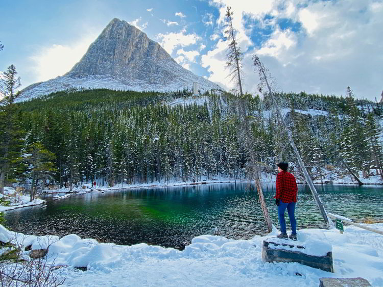 An image of a woman at Grassi Lakes - Canmore winter hikes and snowshoe trails.