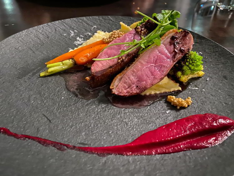 An image of the duck entree at The Sensory Restaurant in Canmore, Alberta, Canada. 