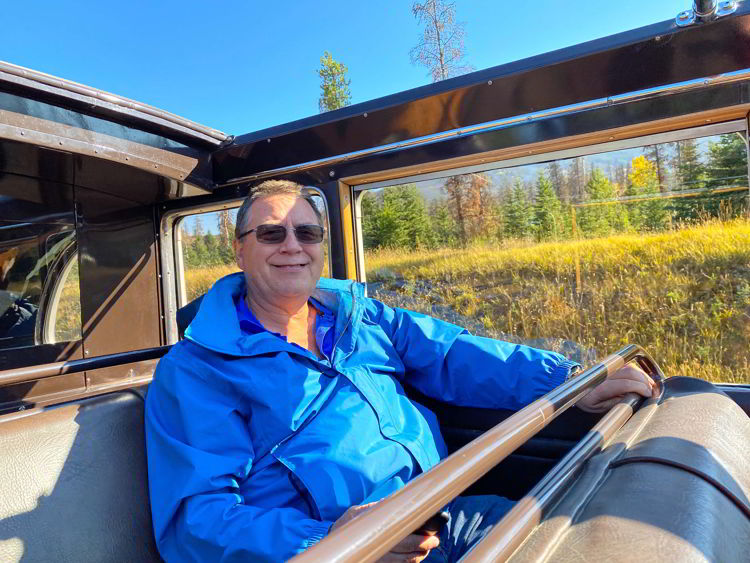 An image of a man sitting in the back of the antique jammer bus on a tour with Sundog Tours in Jasper National Park, Alberta, Canada.