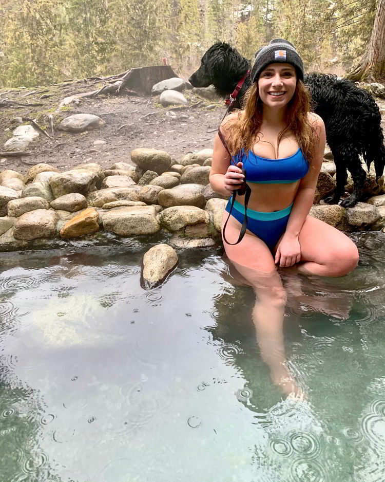 An image of a woman soaking in Halfway Hot Springs in British Columbia, Canada. 