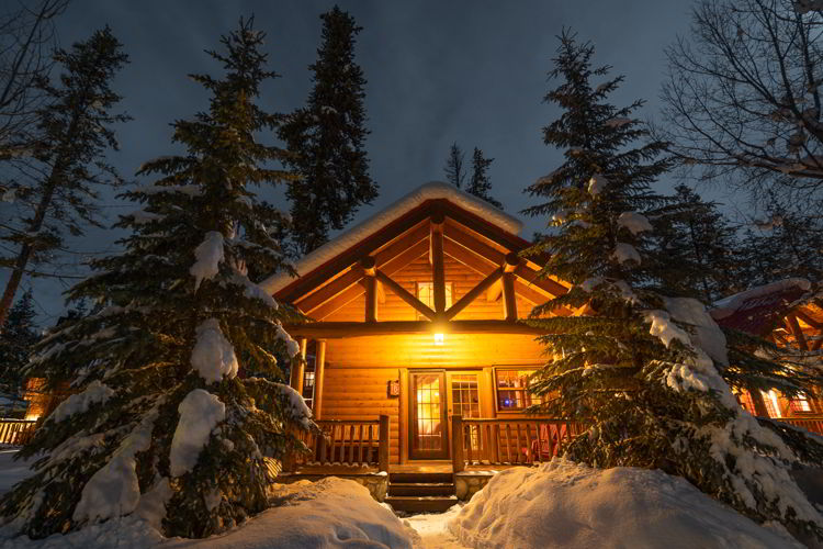 An image of a cabin at Baker Creek Mountain Resort in Banff National Park in winter. 