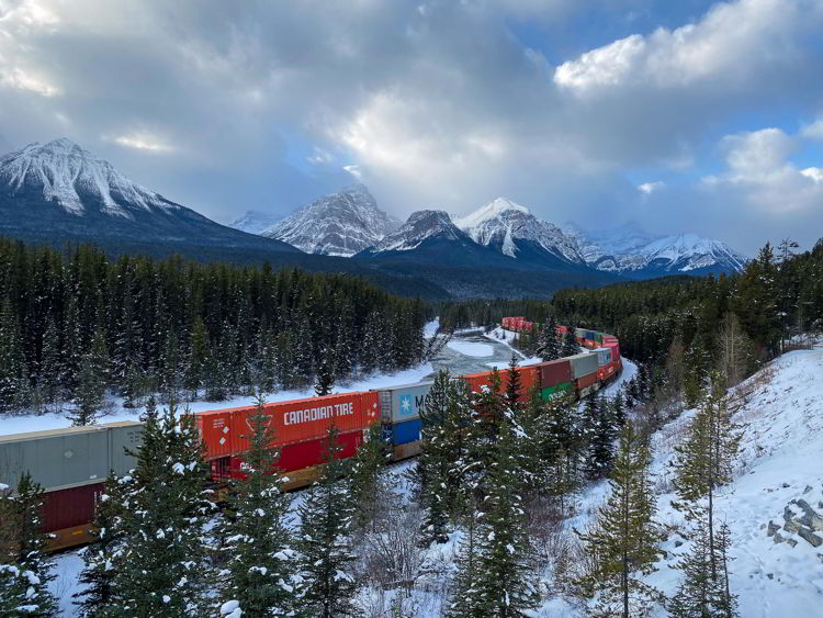 An image of a train on Morant's Curve in Banff National Park, Alberta, Canada. 