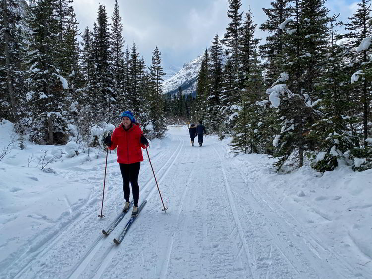 An image of a woman cross-country skiing near Lake Louise, Alberta, Canada.