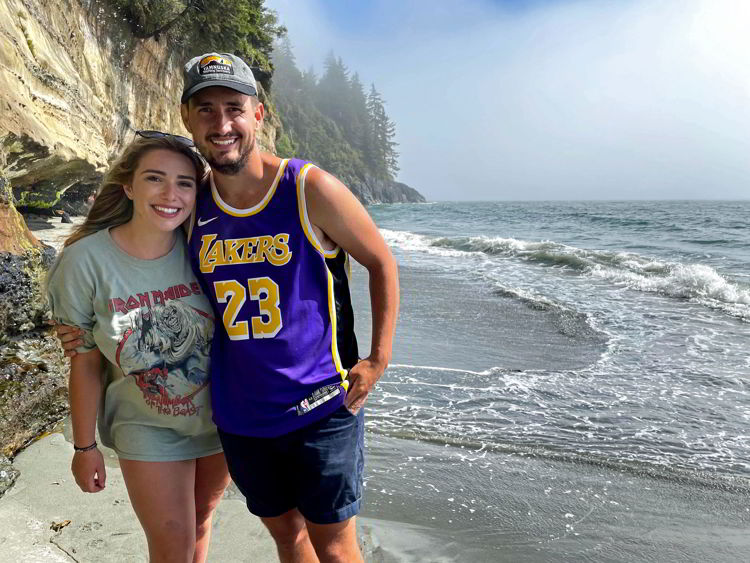 An image of a couple standing on Mystic Beach, Vancouver Island in British Columbia, Canada.