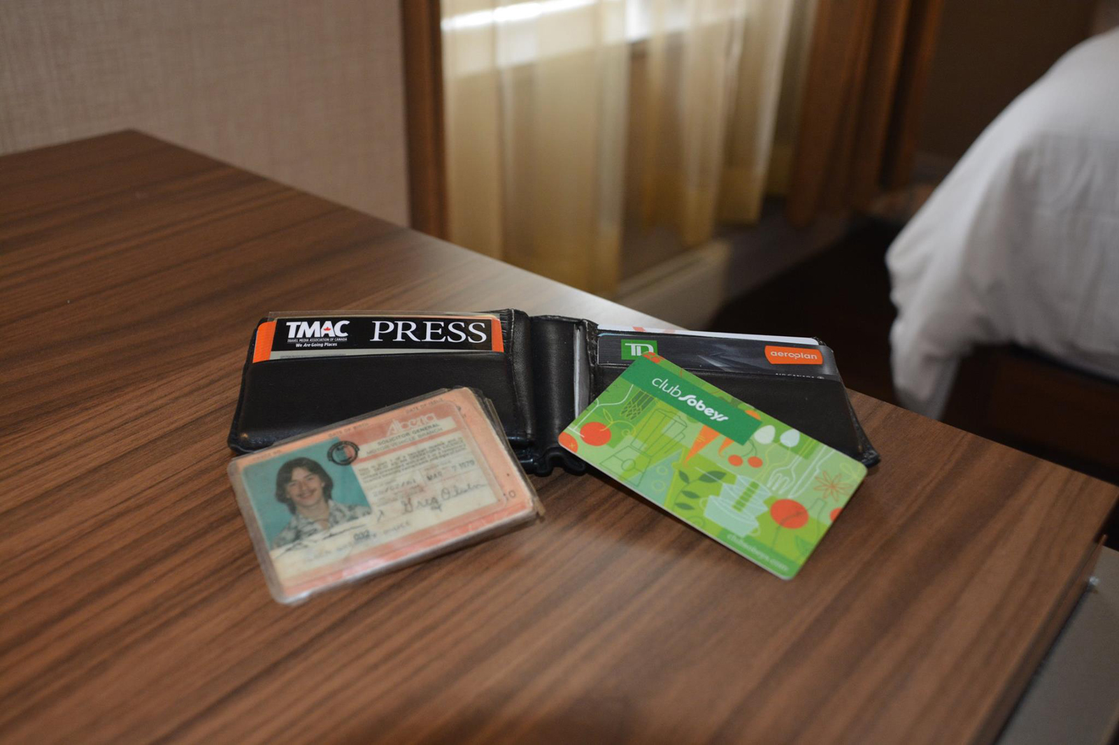 An image of a wallet with an old driver's license and expired cards