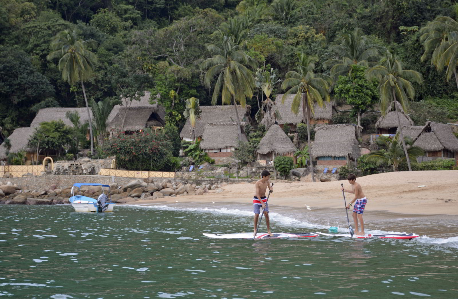 An image of two kids paddleboarding of Yelapa Beach - Jalisco, Mexico