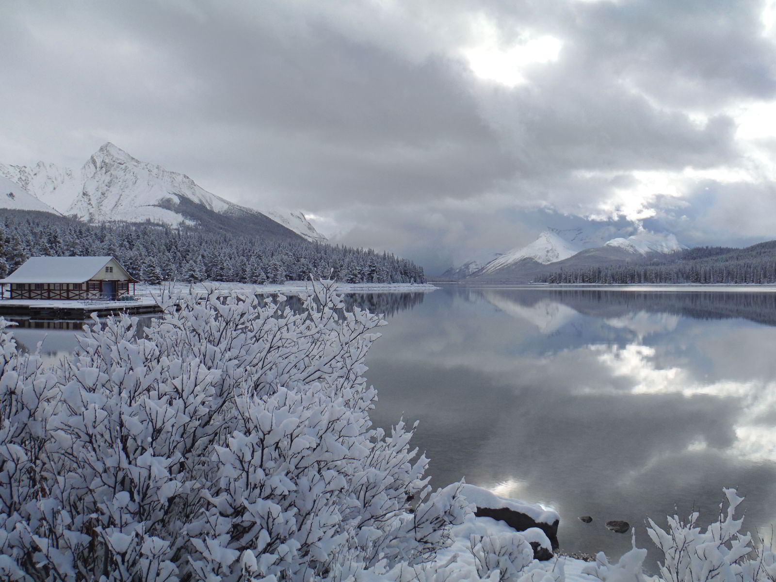 An image of Maligne Lake in Jasper in early winter before the lake has frozen, but after the first snow - Jasper in Winter - 12 Stunning Photographs
