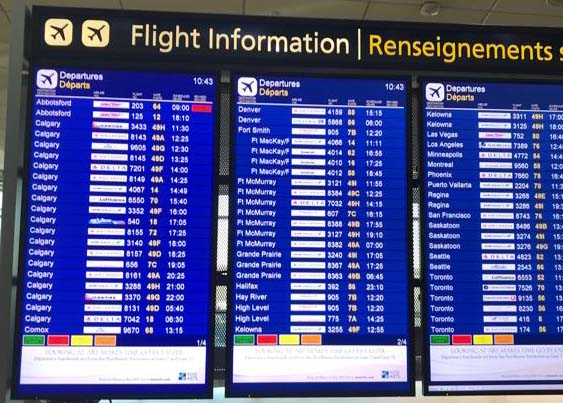 An image of an airport departures board showing Swoop airlines delayed - Swoop Airlines review