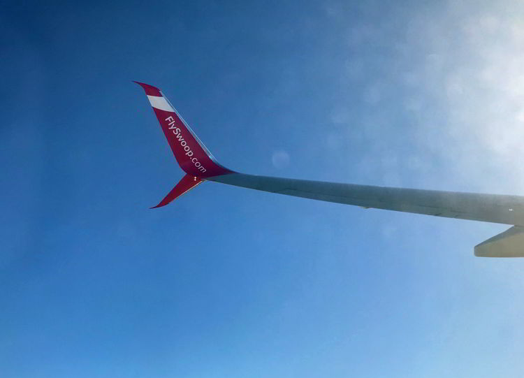 An image of a Swoop Airlines aircraft wing in the air - Swoop Airlines review