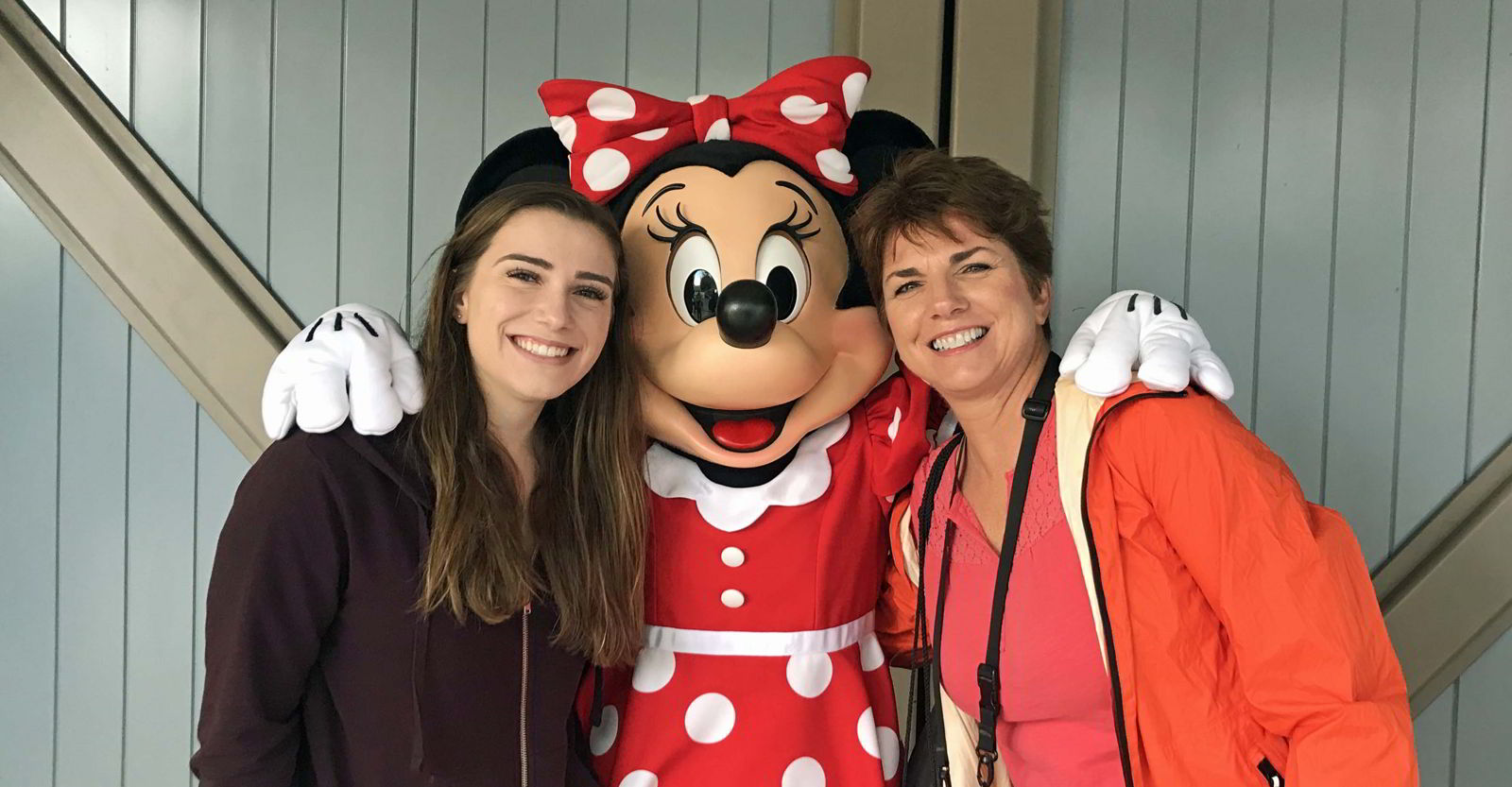An image of two women posing with Minnie Mouse at Disneyland - travel rewards programs