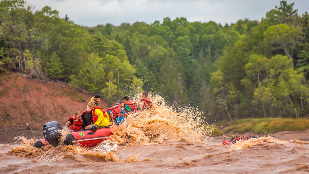 An image of a group of people tidal bore rafting o the Schubenacadie river in Nova Scotia, Canada