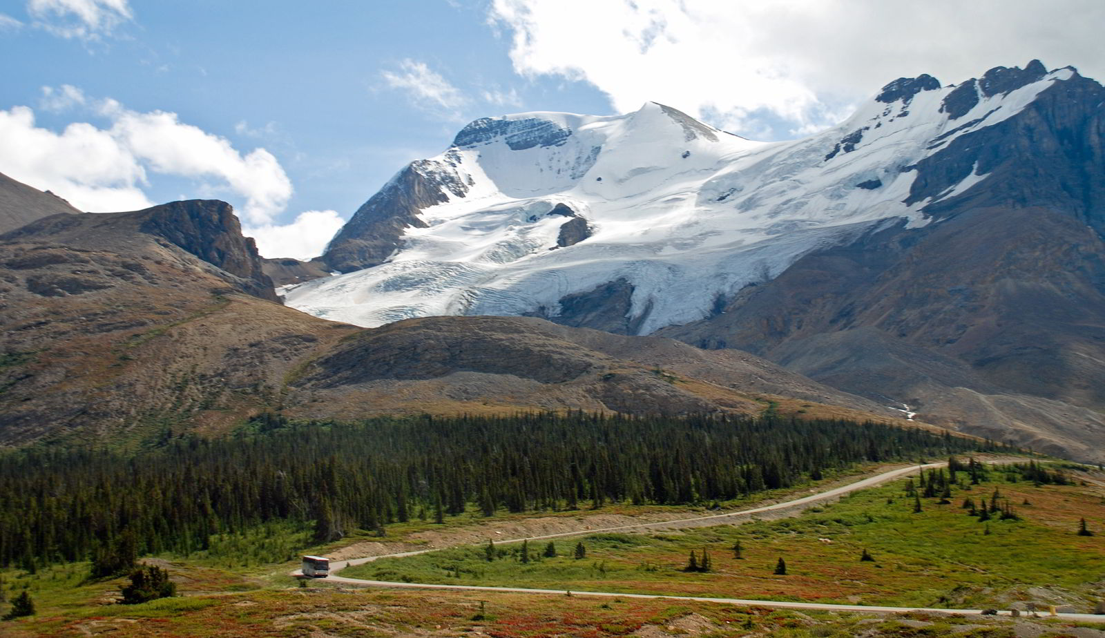 An image of a bus driving along a section of the Icefields Parkway in Jasper National Park, Alberta, Canada - Alberta road trips