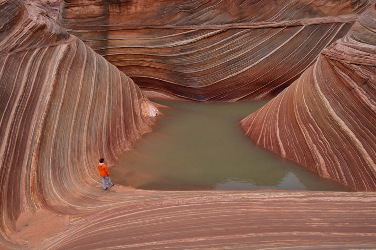 An image of a woman hiking the wave in Arizona, USA. 