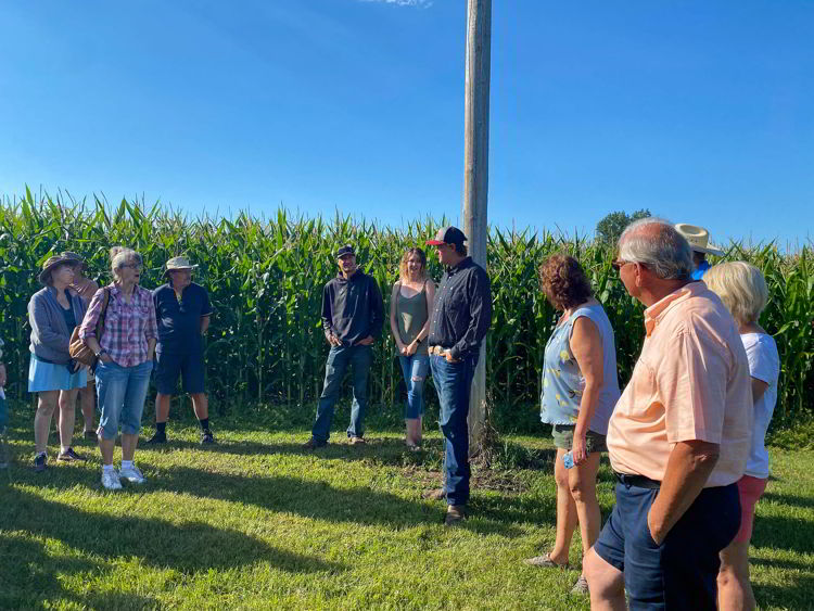 An image of a farmer talking to people at Taste of the Heartland near Stettler, Alberta. 