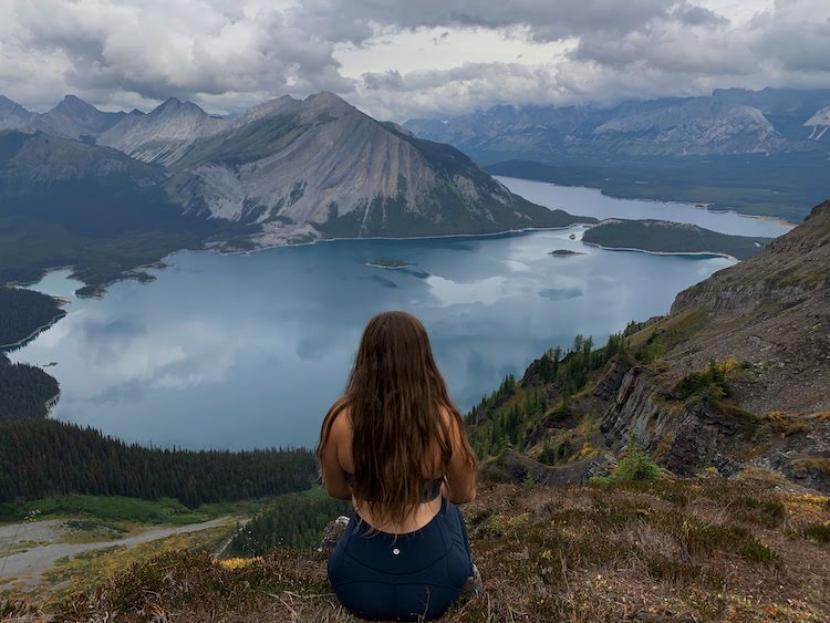 A girl looking at the view at the summit of Sarrail Ridge in Kananaskis.