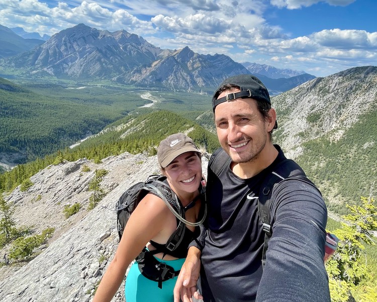 A couple taking a selfie at the summit of Porcupine Ridge in Kananaskis