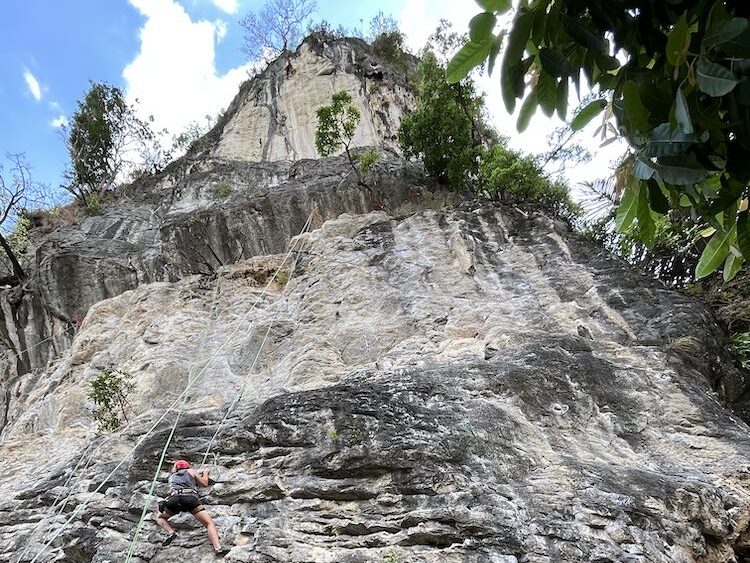 A man rock climbing in Krabi, Thailand.