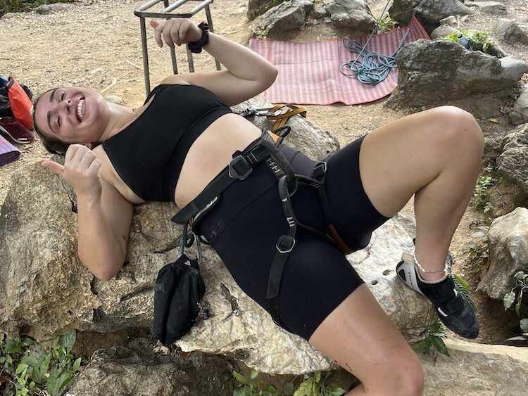 A girl laying down after rock climbing in Krabi, Thailand.