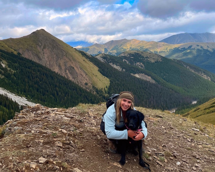 A girl and a dog on mist mountain trail