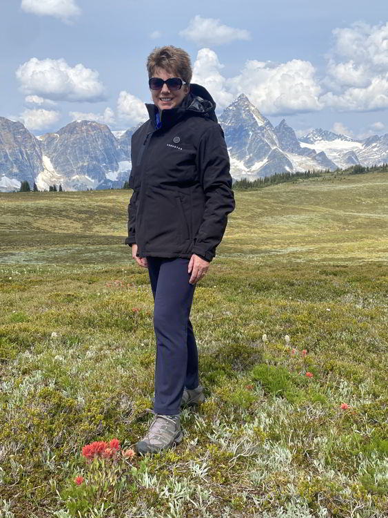 An image of a woman wearing the Ventusas heated jacket in the Purcell Mountains of Canada. 