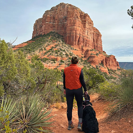 a girl and a dog admiring cathedral rock.