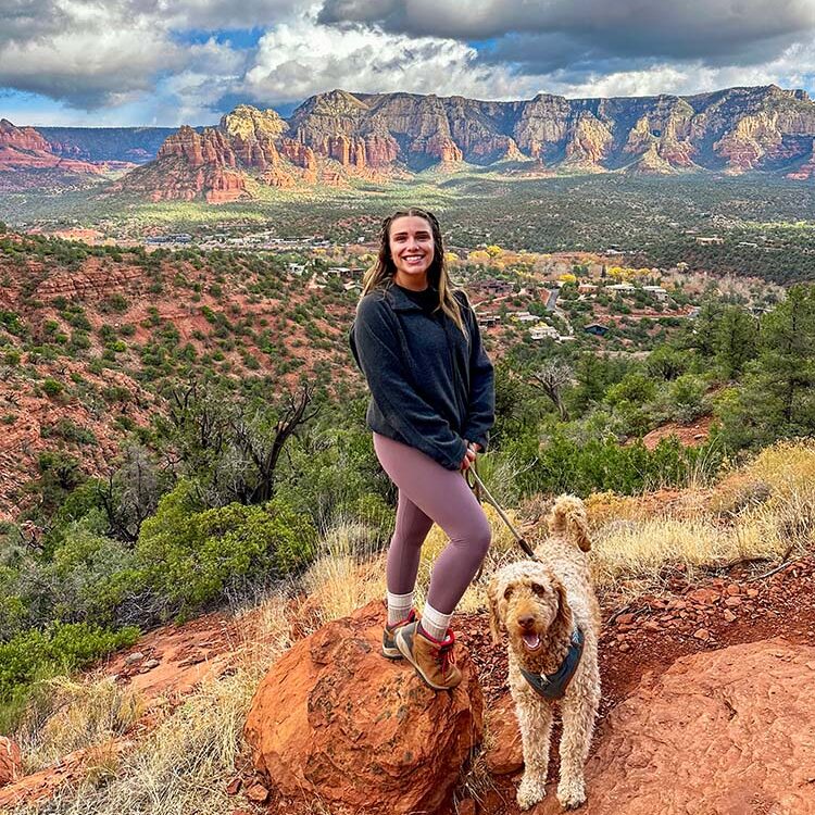 A girl and a dog hiking in Sedona, Arizona.